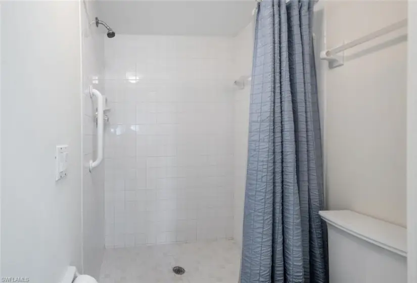 Bathroom featuring a shower with shower curtain