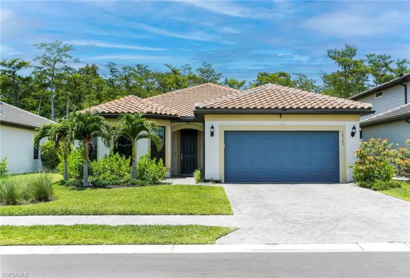 Mediterranean / spanish-style house featuring a front yard and a garage