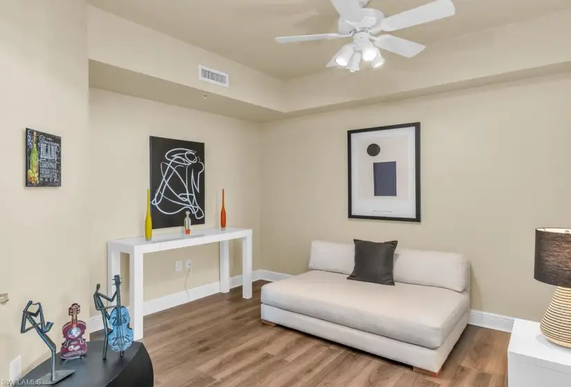 Sitting room featuring wood-type flooring and ceiling fan