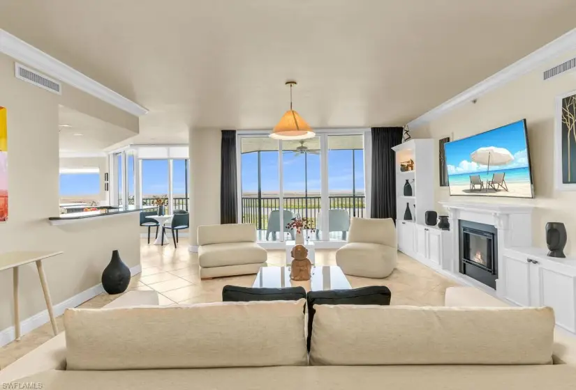 Tiled living room with floor to ceiling windows and crown molding